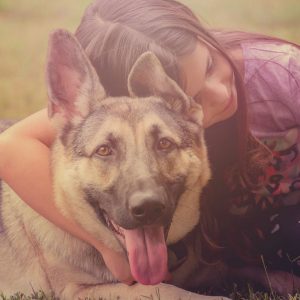 girl cuddling dog