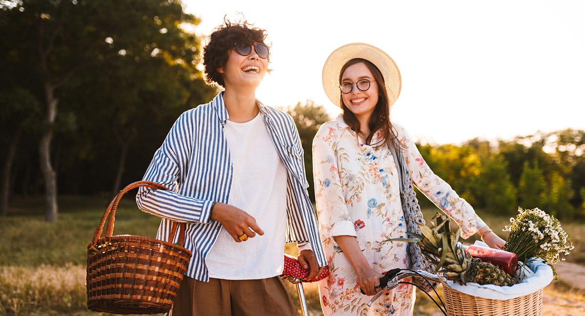 Two women smiling enjoying a walk. ow to use cbd oil for pain. best cbd cream for arthritis pain.