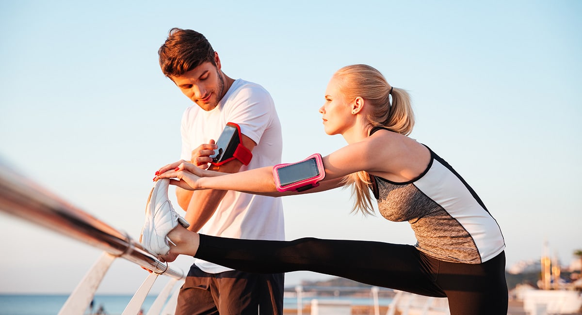 Adult couple streching before a run. CBD cream for pain from muscle recovery. Buy CBD cream and CBD salves online USA.