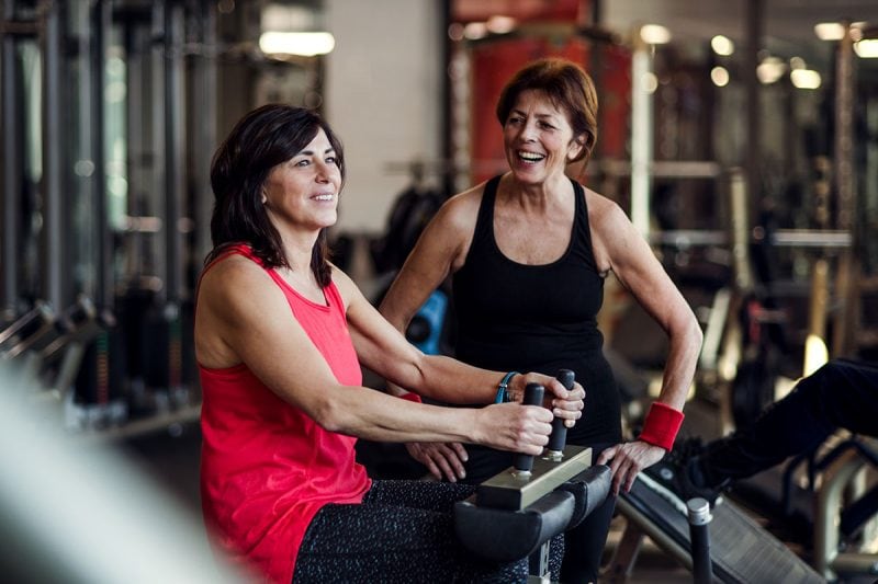 Two senior women happy and active in a gym. CBD cream for pain. Buy CBD salves for pain management.