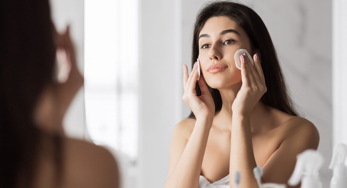 Woman washing face, CBD for skincare. CBD for women's skin. cbd oil and women's hormones. does cbd oil increase estrogen?