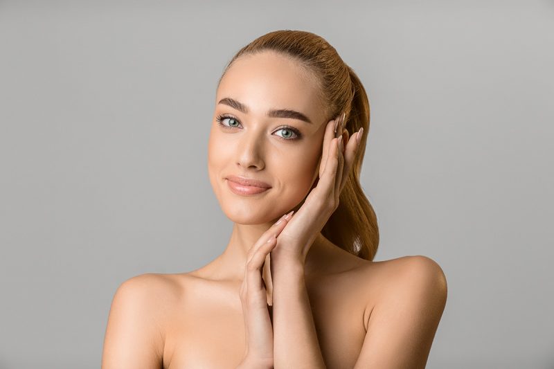 Beautiful women with healthy skin touching her face. Best cbd products for skincare. Buy CBD for wrinkles.