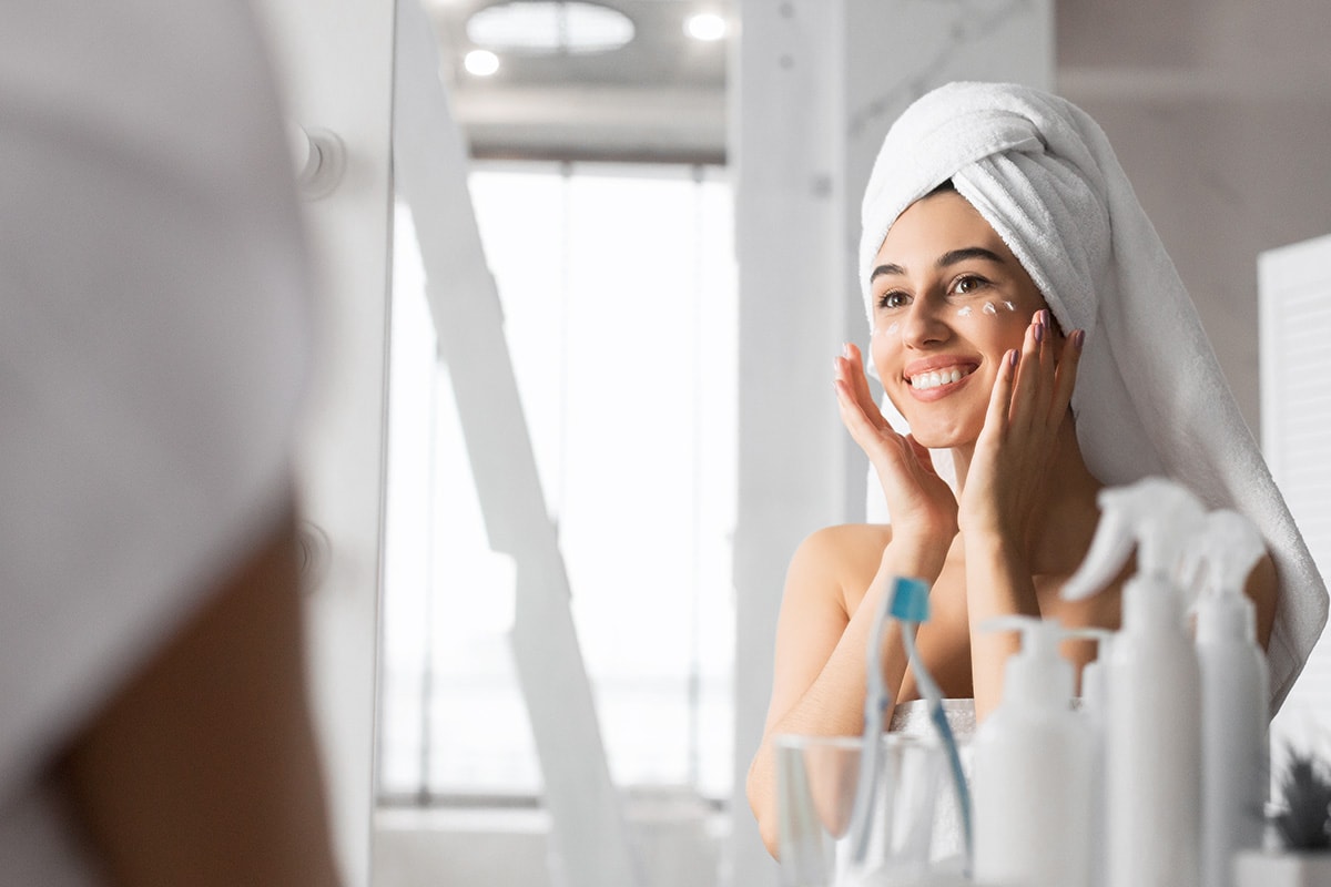 Adult woman applying CBD topical eye cream on skin. Purchase cbd products for skin care online USA.