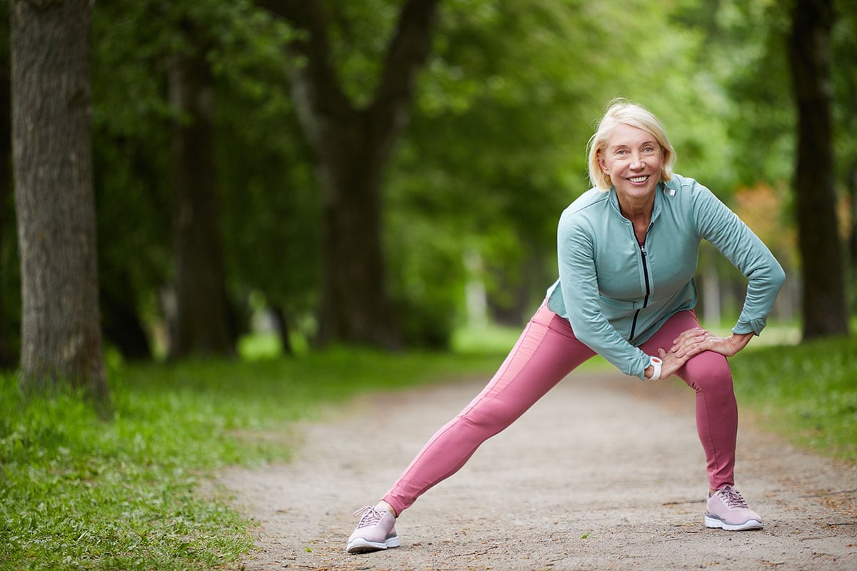 Adult woman active riding bike outdoors. can CBD cream help with back pain relief? Can CBD Cream Help Back Pain?